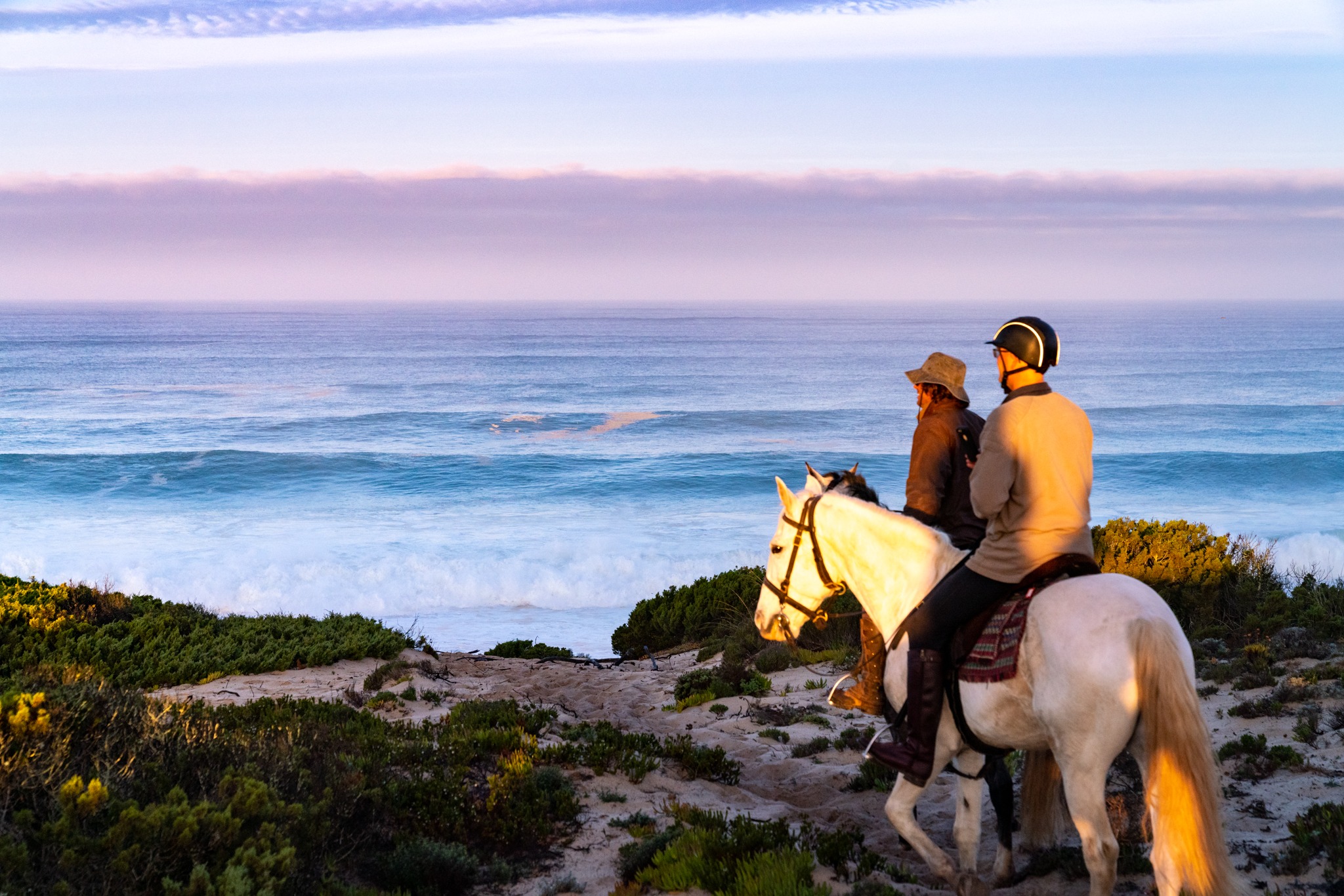 riders on beach sand dunes at sunset portugal horse riding holiday by globetrotting
