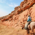 rider in canyon on horse riding holiday Wyoming by globetrotting
